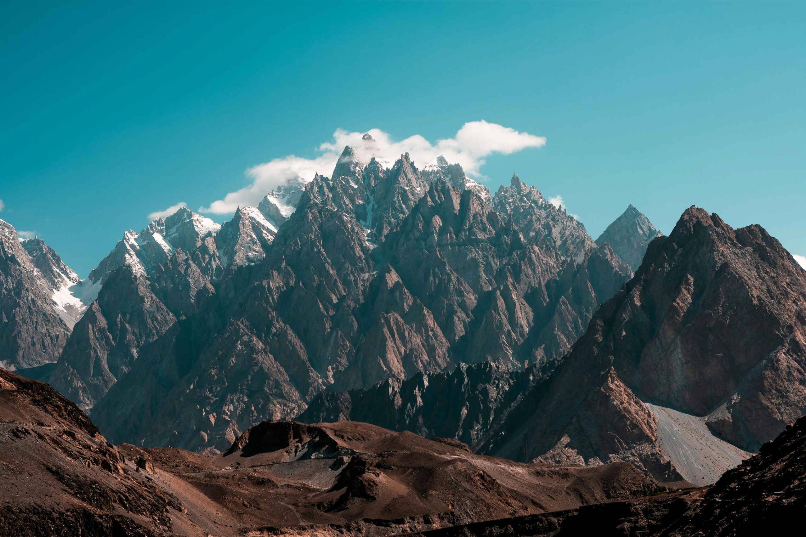 Breathtaking view of the Passu Cones in Hunza, featuring rugged peaks under a clear blue sky.